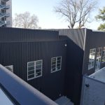 Black metal siding installed on building