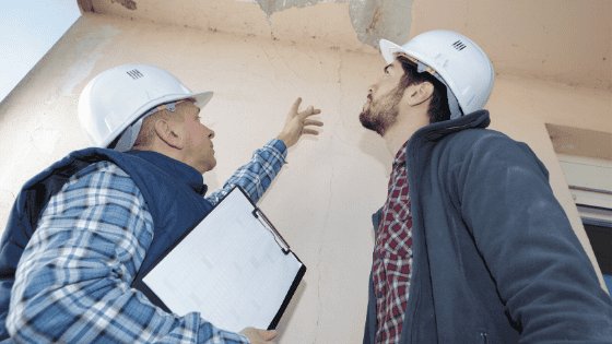 Workers inspecting a roof leak