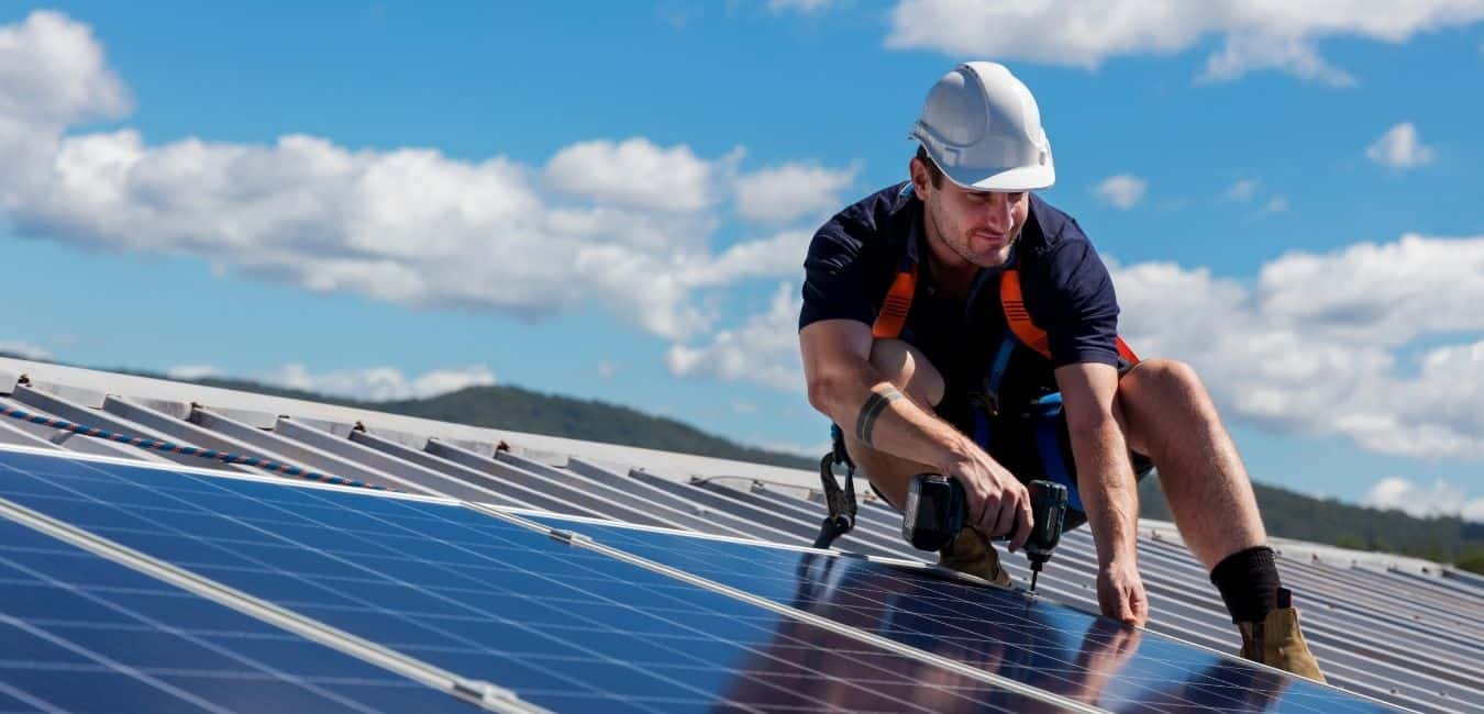 Worker installing solar panels
